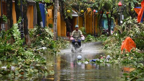 A man on a motorbike drives through a flooded street following the passage of Typhoon Noru in Hoi An city, Quang Nam province on September 28, 2022.