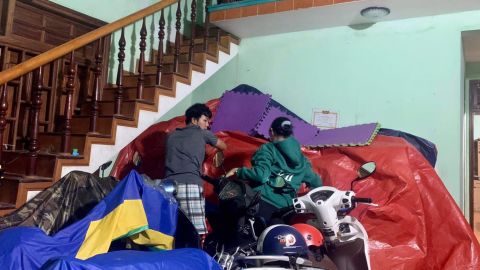 People try to protect motorbikes from floods in Que Son district, Quang Nam province, Vietnam.