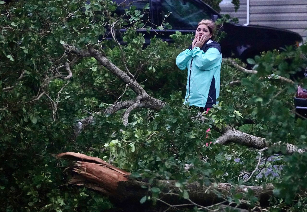 Zuram Rodriguez surveys the damage around her home in Davie, Florida, early Wednesday.