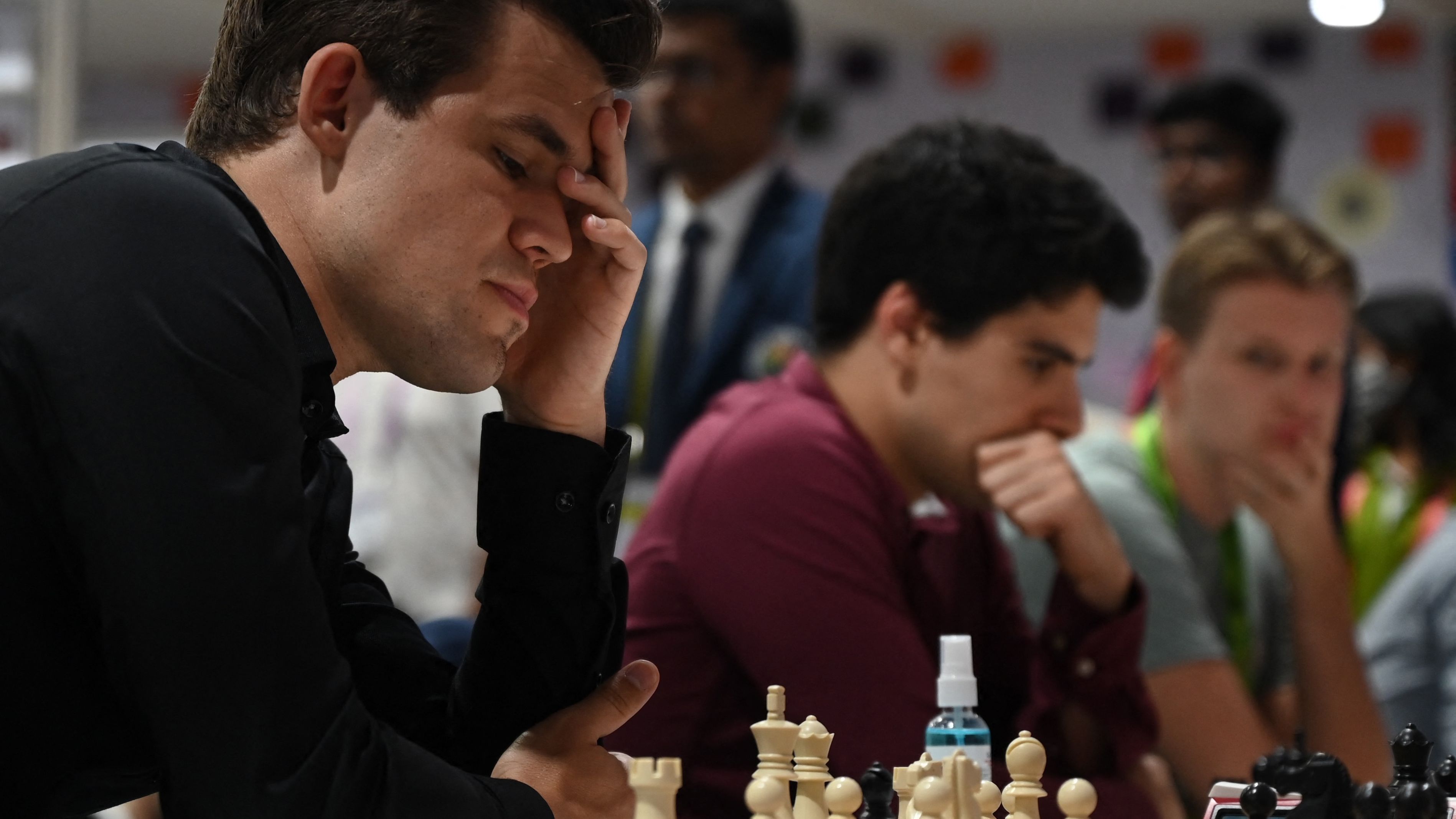 Carlsen mulls over a move during his round 8 game against the Slovakia team at the 44th Chess Olympiad.