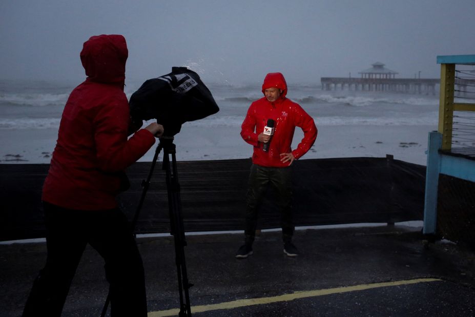 A TV crew broadcasts from the beach in Fort Myers on Wednesday.