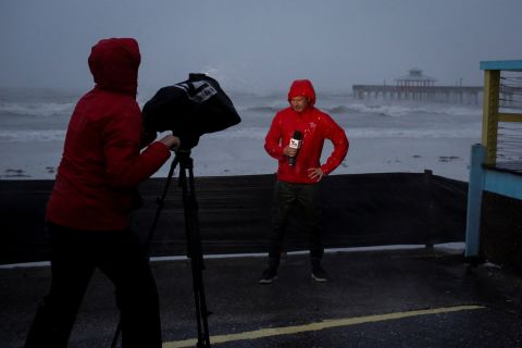 A TV crew broadcasts from the beach in Fort Myers, Florida, on Wednesday.