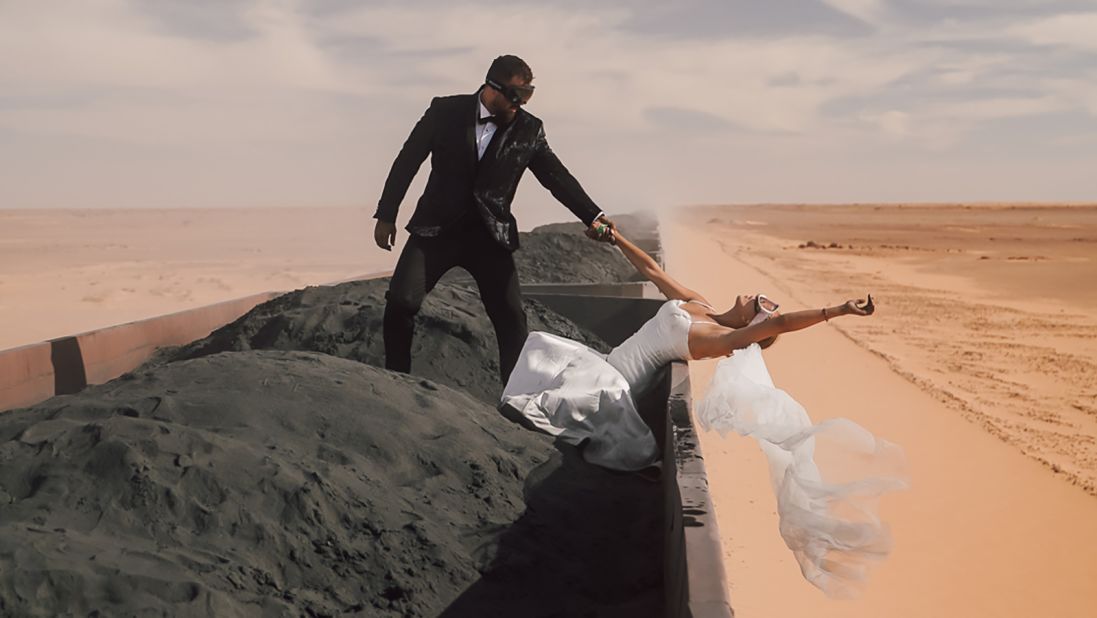 <strong>Wedding train: </strong>Croatian newlyweds Kristijan and Andrea Ilicic hopped on a freight train carrying wagons of dirty iron ore across the baking hot deserts of Mauritania in northwest Africa to celebrate their marriage.
