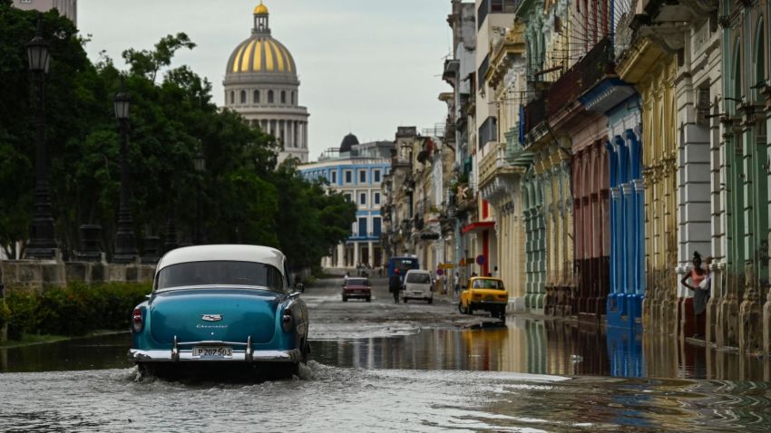 An old American car passes through a flooded street in Havana, on September 28, 2022, after the passage of hurricane Ian. - Cuba exceeded 12 hours this Wednesday in total blackout with "zero electricity generation" due to failures in the links of the national electrical system (sen), after the passage of powerful Hurricane Ian. (Photo by YAMIL LAGE / AFP) (Photo by YAMIL LAGE/AFP via Getty Images)