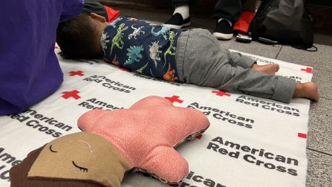 A child sleeps at the El Paso airport after his family's one month journey from Venezuela. According to the child's father, the family is seeking asylum in the United States. 