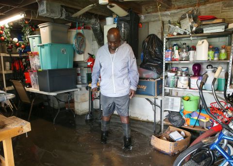 Melvin Phillips stands in the flooded basement of his mobile home in Stuart, Florida, on Wednesday.