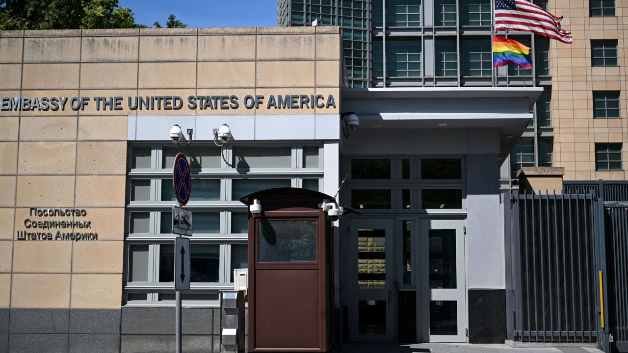 US national (top) and rainbow flags are pictured on the US embassy in Moscow on June 30, 2022. - Moscow officials changed the official address of the US embassy building in the Russian capital to one named after pro-Kremlin separatists in Ukraine on June 22. (Photo by Natalia KOLESNIKOVA / AFP) (Photo by NATALIA KOLESNIKOVA/AFP via Getty Images)