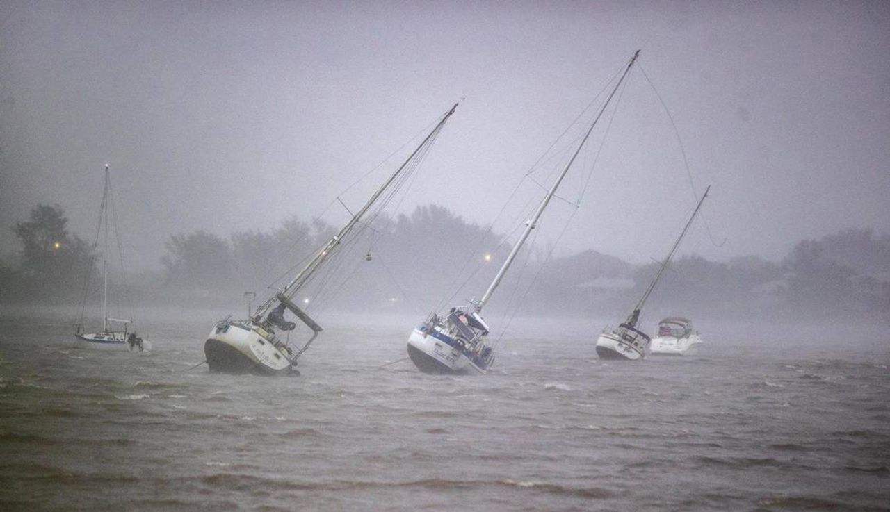 Sailboats anchored in Roberts Bay are blown around in Venice, Florida, on Wednesday.