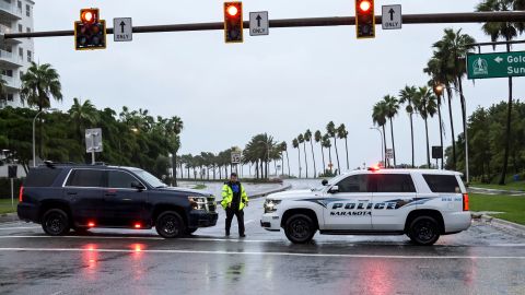 Sarasota County Sheriff Deputies block the access to a downtown bridge over to the barrier islands as Hurricane Ian approaches Florida's Gulf Coast on September 28.