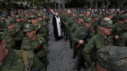 An Orthodox priest conducts a service for reservists drafted as part of the partial mobilization, during a ceremony of their departure for military bases, in Sevastopol, Crimea on September 27, 2022.
