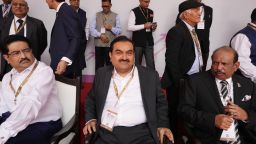 Industrialist Gautam Adani, center, sits for a group photograph during a ceremony in the northern Indian state of Uttar Pradesh, India, on June 3.