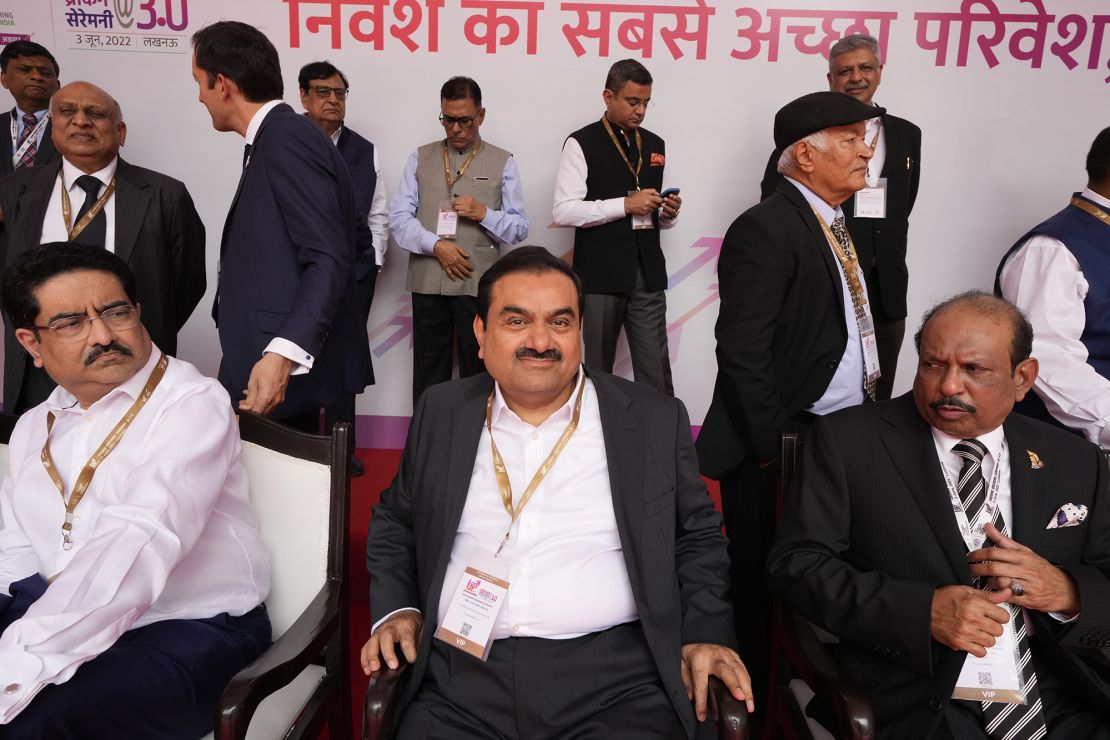 Gautam Adani, center, sits for a group photograph during a ceremony in the northern Indian state of Uttar Pradesh, India, on June 3.