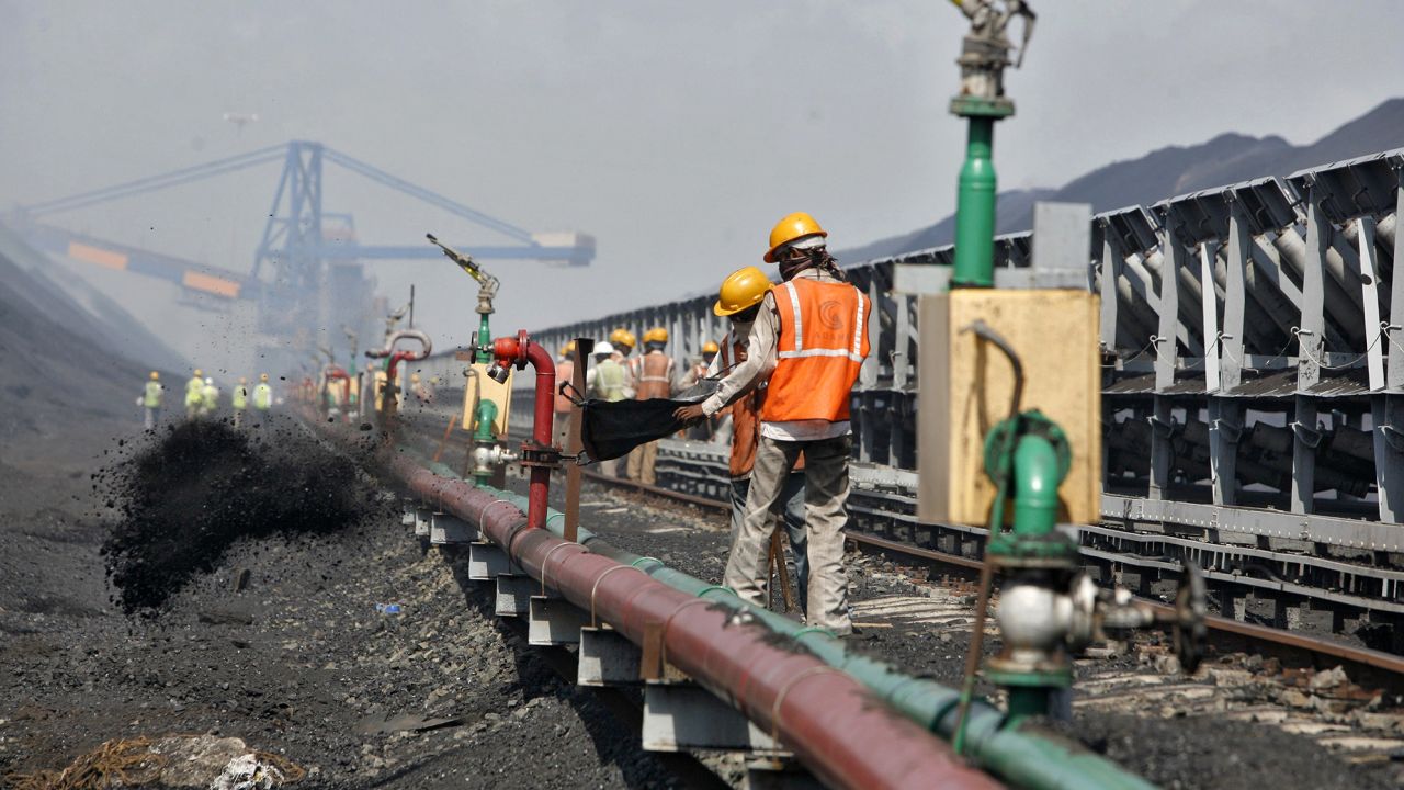 Workers at a coal port at Mundra in the western Indian state of Gujarat on September 24, 2012.