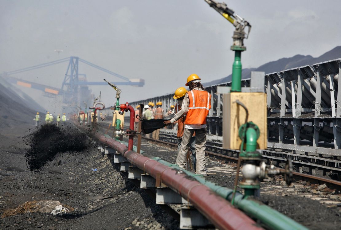 Workers at a coal port at Mundra in the western Indian state of Gujarat on September 24, 2012. 