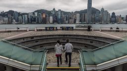 A couple visits a viewing deck before the city skyline in Hong Kong on March 29, 2022. (Photo by DALE DE LA REY / AFP) (Photo by DALE DE LA REY/AFP via Getty Images)