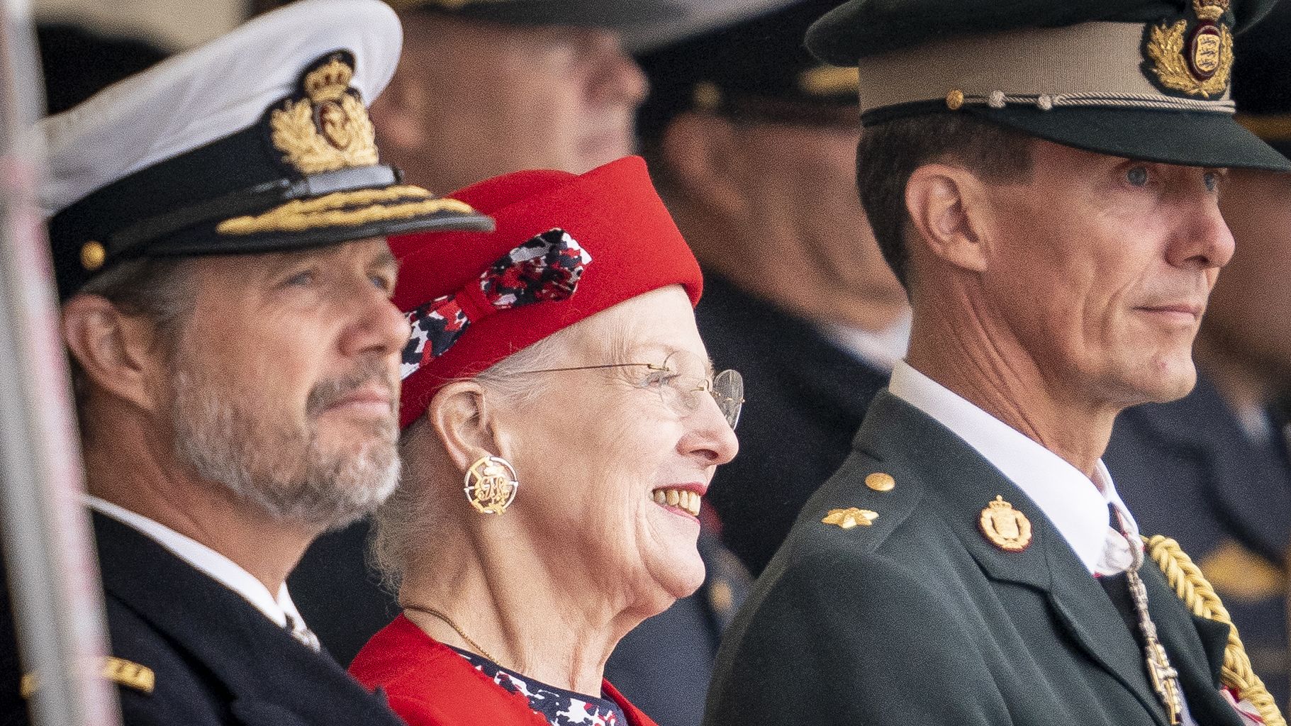 Queen Margrethe is flanked by her sons Crown Prince Frederik (L) and Prince Joachim (R) as she attends festivities in Korsoer, Denmark on August 29, to celebrate 50 years on the throne. 