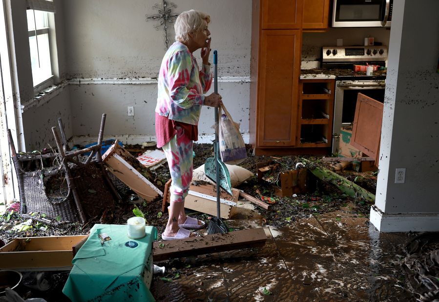Stedi Scuderi looks over her flooded apartment in Fort Myers on Thursday.