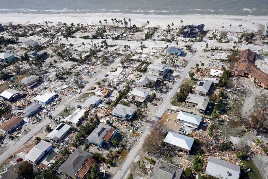 This aerial photo shows damaged homes and debris in Fort Myers Beach on Thursday.