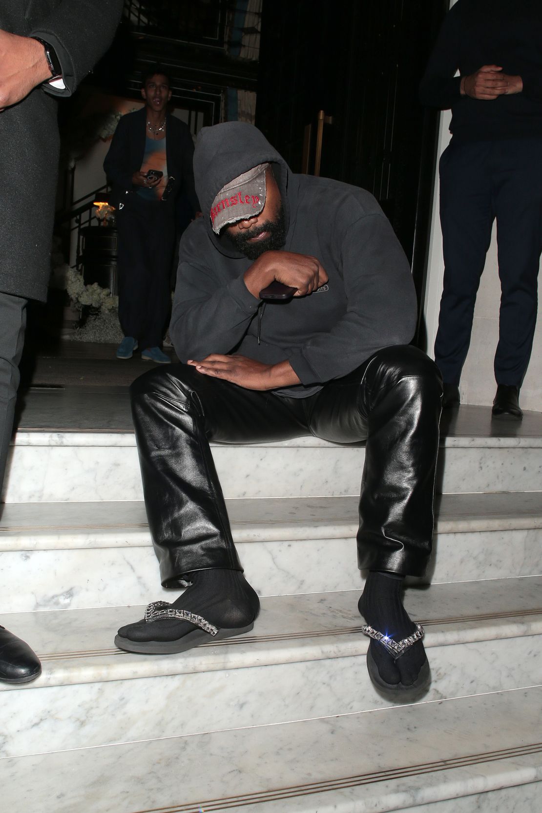 Kanye West debuted his bejeweled flip-flops at Burberry's London Fashion Week showcase.