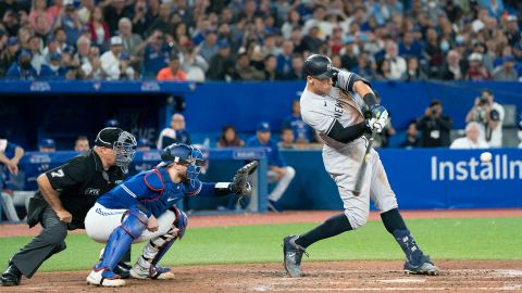 New York Yankees designated hitter Aaron Judge (99) hits his 61st home run scoring two runs against the Toronto Blue Jays during the seventh inning at Rogers Centre. 