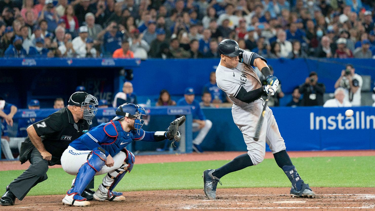 New York Yankees designated hitter Aaron Judge (99) hits his 61st home run scoring two runs against the Toronto Blue Jays during the seventh inning at Rogers Centre. 