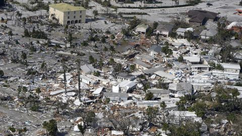 Damaged homes and debris are shown in the aftermath of Hurricane Ian in Fort Myers, FL.