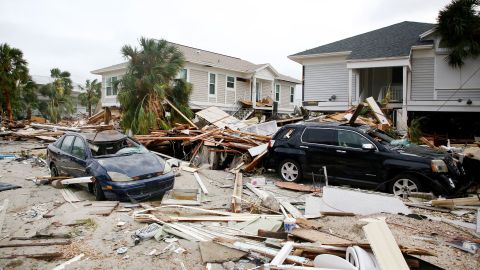 Pieces of homes and cars are strewn across Fort Myers Beach on Thursday. 