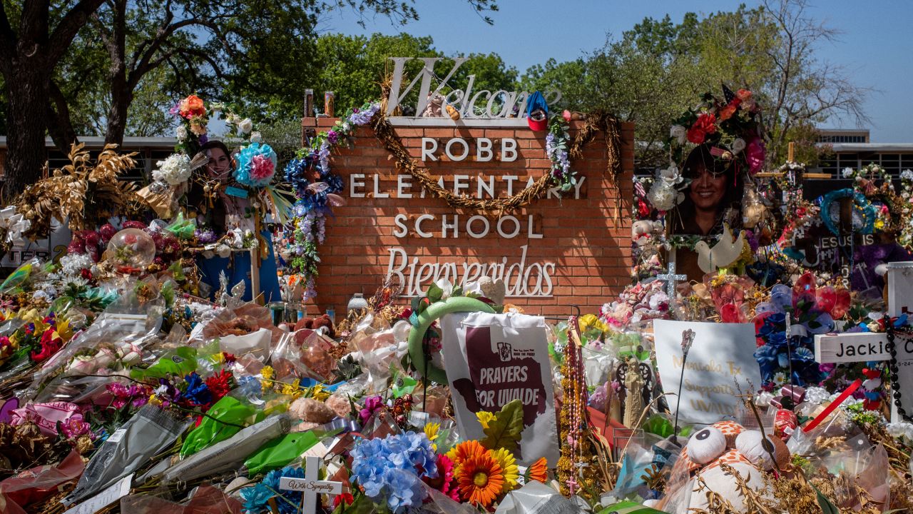 The Robb Elementary School sign is covered in flowers and gifts on June 17 in Uvalde, Texas, after a mass shooting that left 19 children and two adults dead.