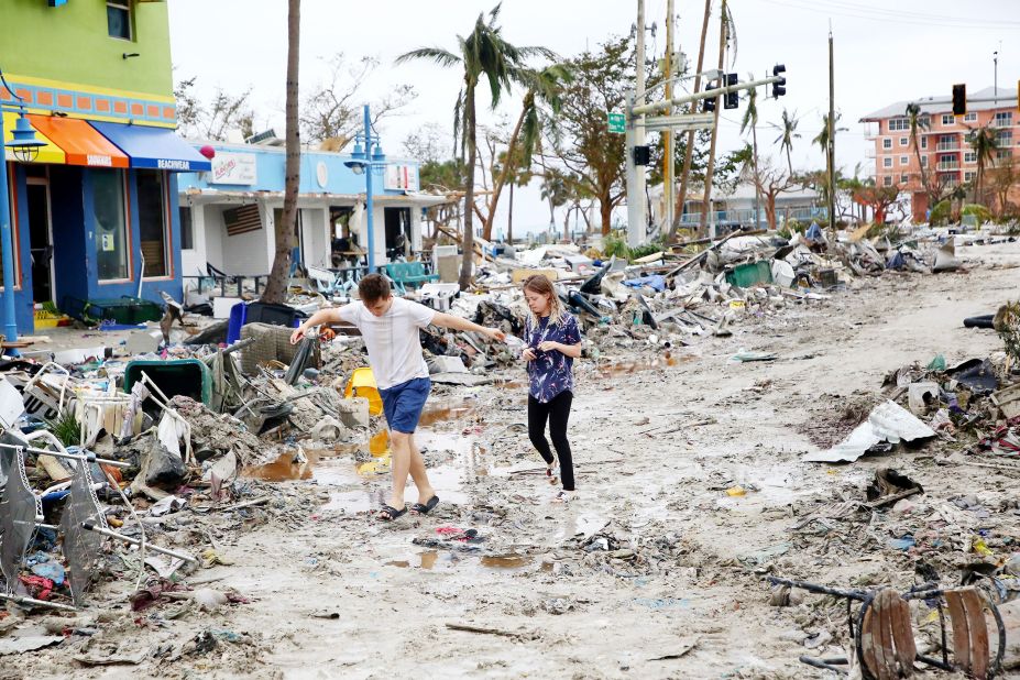 Jake Moses and Heather Jones explore a section of destroyed businesses in Fort Myers Beach, Florida, on Thursday.