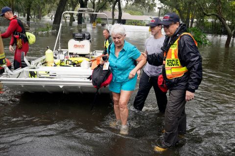 An Orlando resident is rescued from floodwaters on Thursday.