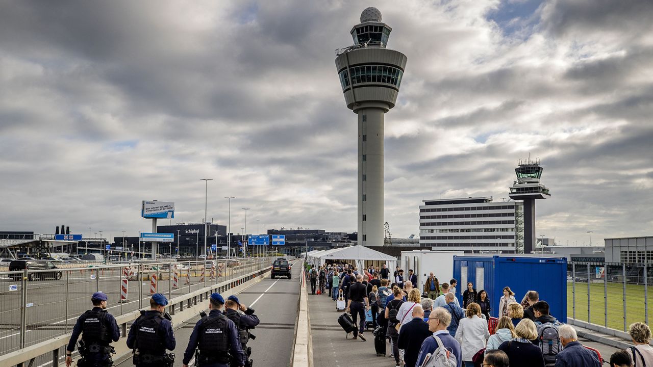 Travelers queue outside Schiphol airport, on September 13, 2022, after Schiphol Airport asked a number of airlines to cancel flights due to a shortage of security personnel. - Netherlands OUT (Photo by Sem van der Wal / ANP / AFP) / Netherlands OUT (Photo by SEM VAN DER WAL/ANP/AFP via Getty Images)
