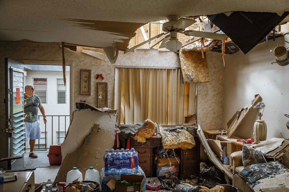 Bob Levitt returns to his condemned home to retrieve his cat, which he found hiding in a bedroom Thursday in Palm Beach County, Florida. A tornado spawned by the hurricane left residents homeless.