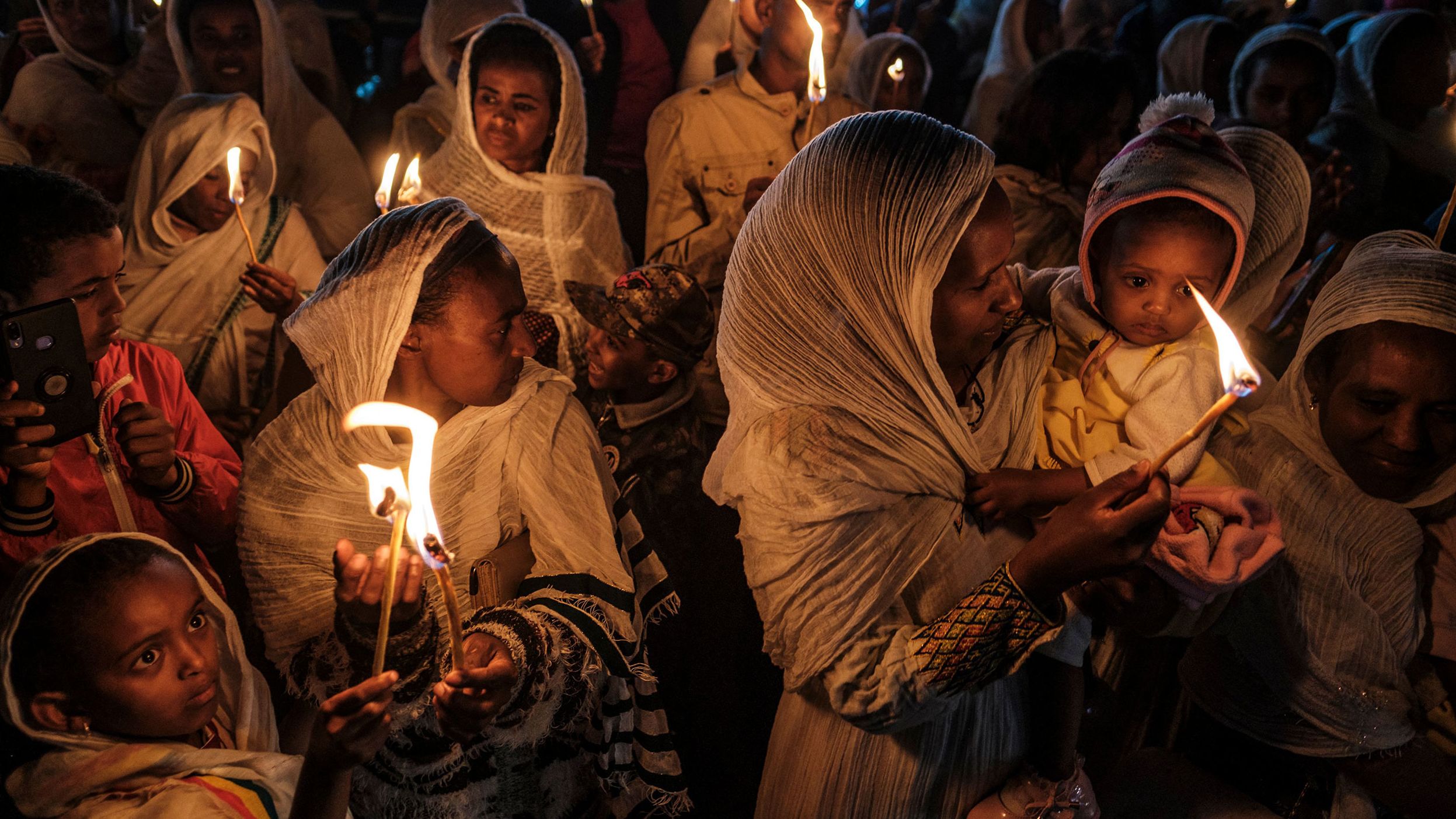 People in Addis Ababa, Ethiopia, hold candles Monday, September 26, during celebrations that were held on the eve of the Ethiopian Orthodox holiday of Meskel.