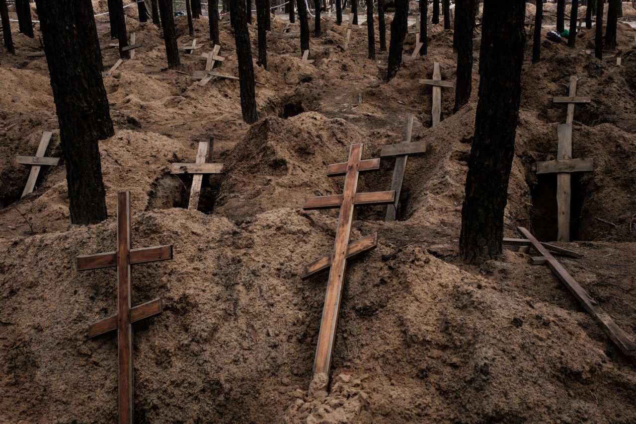 Empty graves are seen in Izium, Ukraine, on Sunday, September 25, after <a href="https://www.cnn.com/2022/09/23/europe/ukraine-izium-mass-burial-bodies-recovered-torture-intl-hnk/index.html" target="_blank">bodies were exhumed.</a> Ukrainian officials said that of the 436 bodies found, 30 showed signs of torture. Izium, which sits near the border between the Kharkiv and Donetsk regions of Ukraine, was subject to intense Russian artillery attacks in April before it was occupied. It then became an important hub for the invading military during five months of occupation. Ukrainian forces took back control of the city this month, delivering a strategic blow to Russia's military assault in the east.