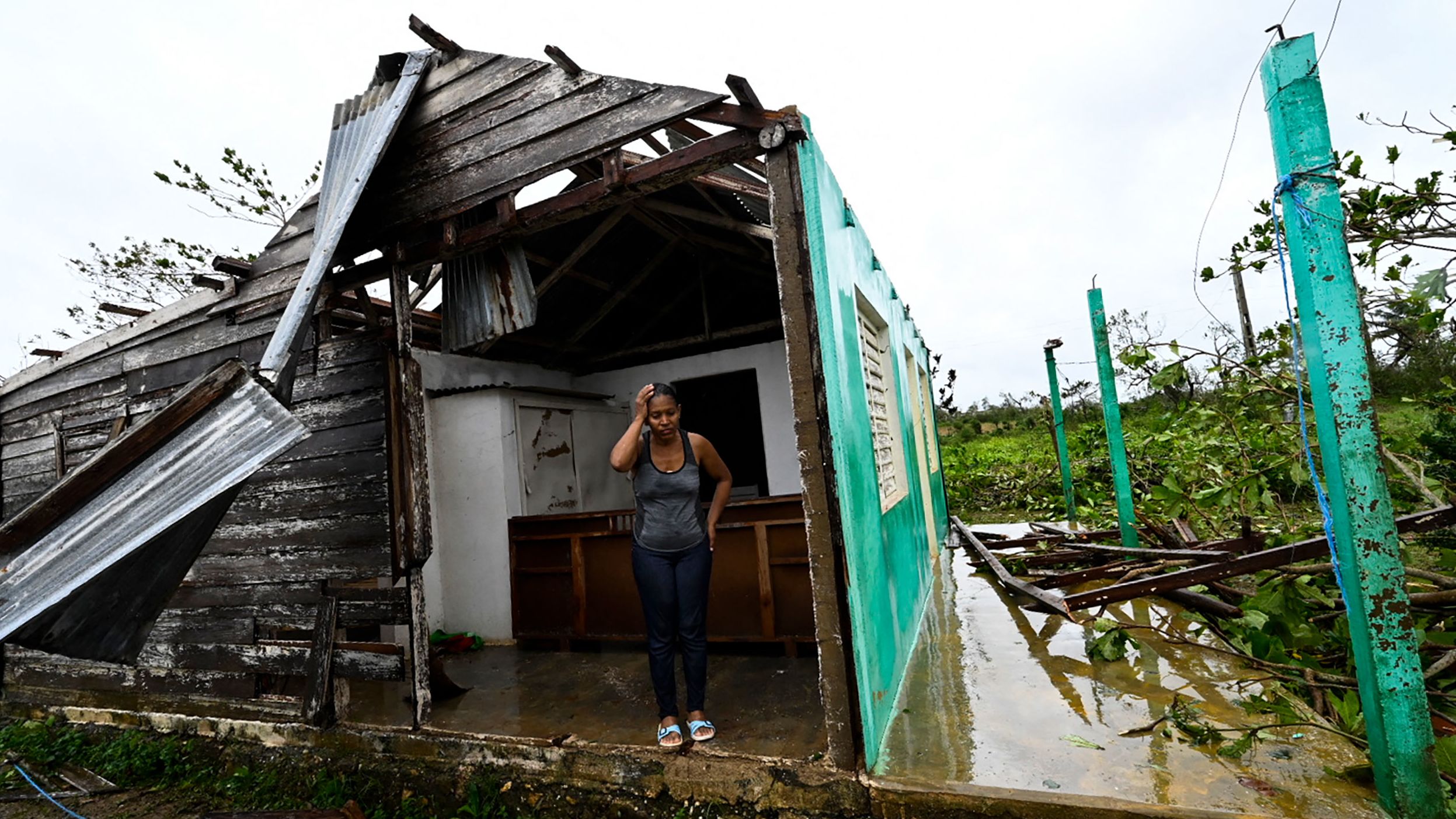 Caridad Alvarez stands in her hurricane-damaged home in San Juan y Martinez, Cuba, on Tuesday, September 27. Hurricane Ian <a href="https://www.cnn.com/2022/09/27/americas/hurricane-ian-cuba-blackout-intl-hnk/index.html" target="_blank">left the entire island without power.</a>
