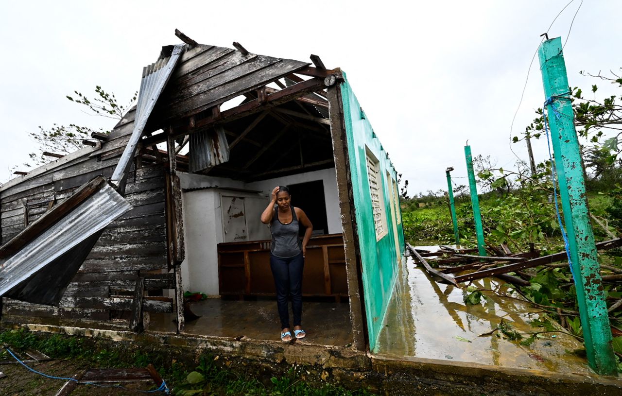 Caridad Alvarez stands in her hurricane-damaged home in San Juan y Martinez, Cuba, on Tuesday, September 27. Hurricane Ian <a href="https://www.cnn.com/2022/09/27/americas/hurricane-ian-cuba-blackout-intl-hnk/index.html" target="_blank">left the entire island without power.</a>