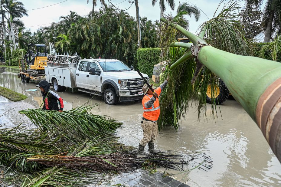 Workers in Naples, Florida, clean up debris on Thursday.