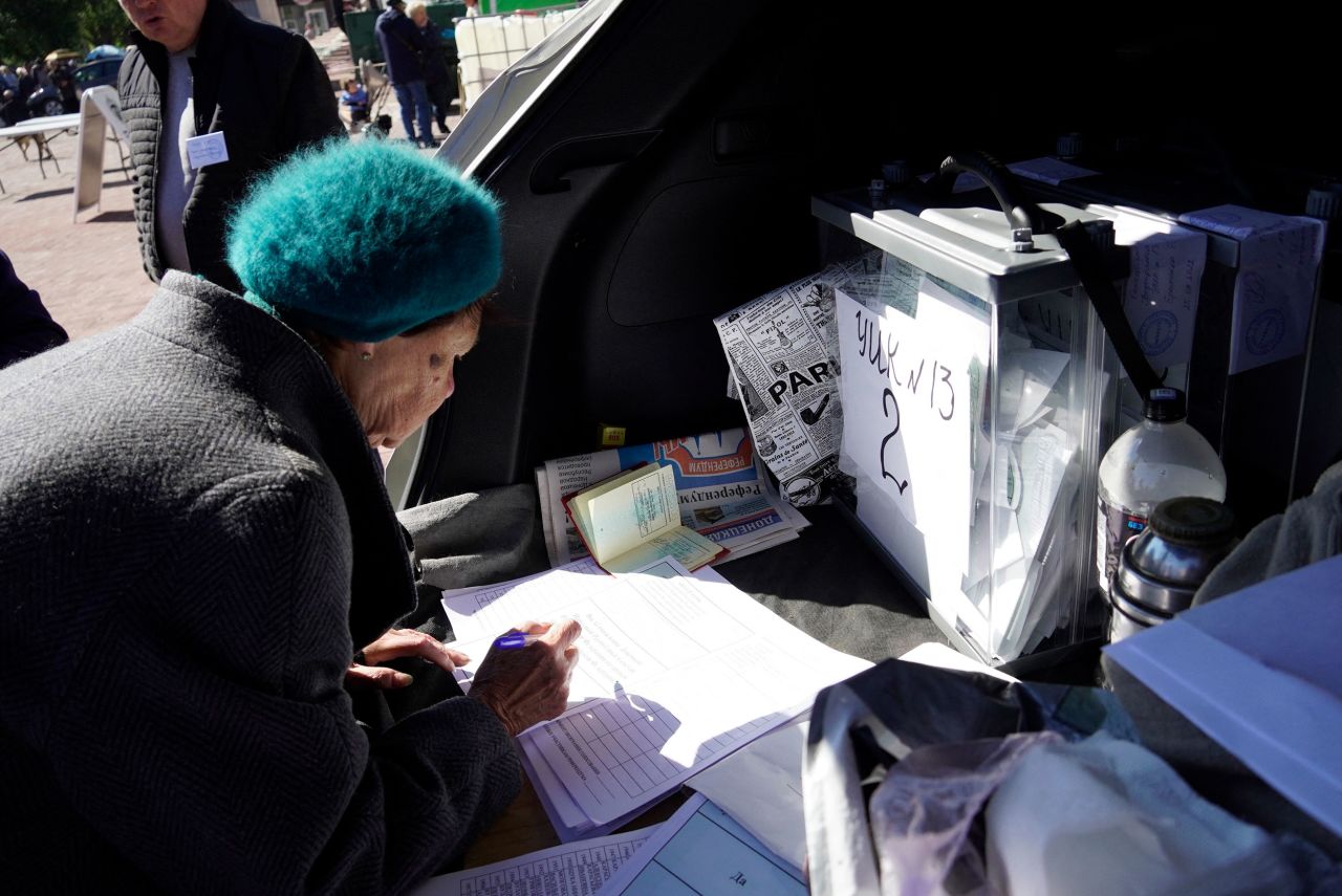 A woman casts a vote in Mariupol, Ukraine, on Sunday, September 25. Pro-Russian authorities have held <a href="https://www.cnn.com/2022/09/27/europe/ukraine-russia-referendum-explainer-intl" target="_blank">so-called referendums</a> in four regions of Ukraine, and while the votes are illegal and have been universally dismissed as "a sham" by Ukraine and Western nations, there are fears that they could create a pretext for a new, dangerous stage in the war.