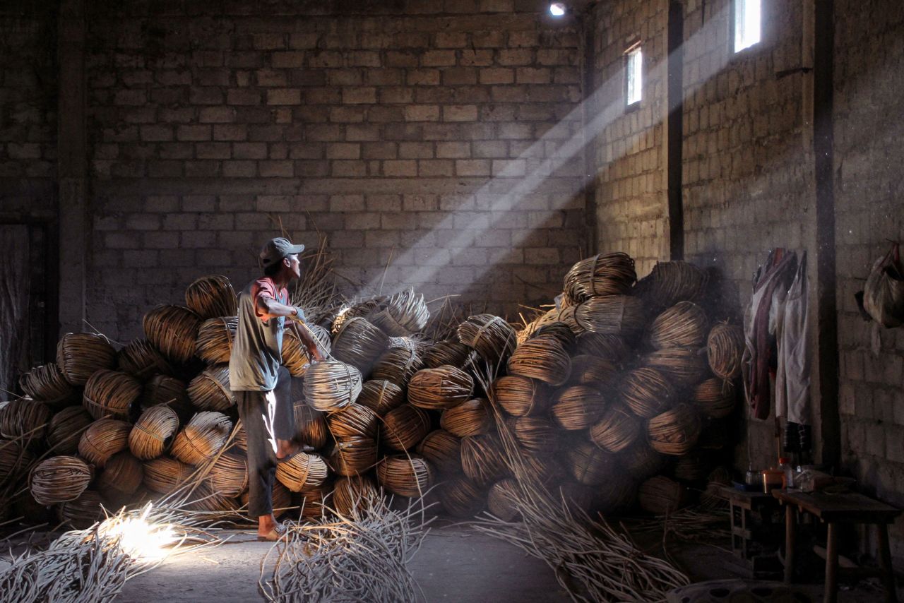 A craftsman works on rattan coffins in Trangsan, Indonesia, on Thursday, September 22.