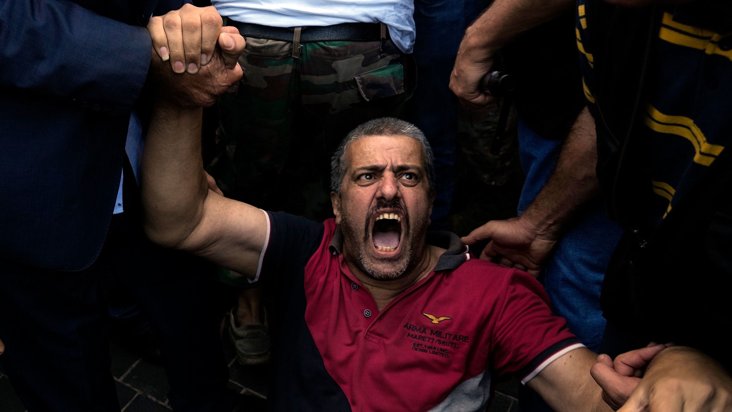 A retired army member lies on the ground and chants slogans as other protesters try to enter Lebanon's parliament building in Beirut on Monday, September 26. Protesters were demanding an increase in their monthly retirement pay, which has been affected by <a href="https://www.cnn.com/2022/09/22/asia/lebanon-banks-shut-holdups-intl/index.html" target="_blank">the country's financial crisis.</a>