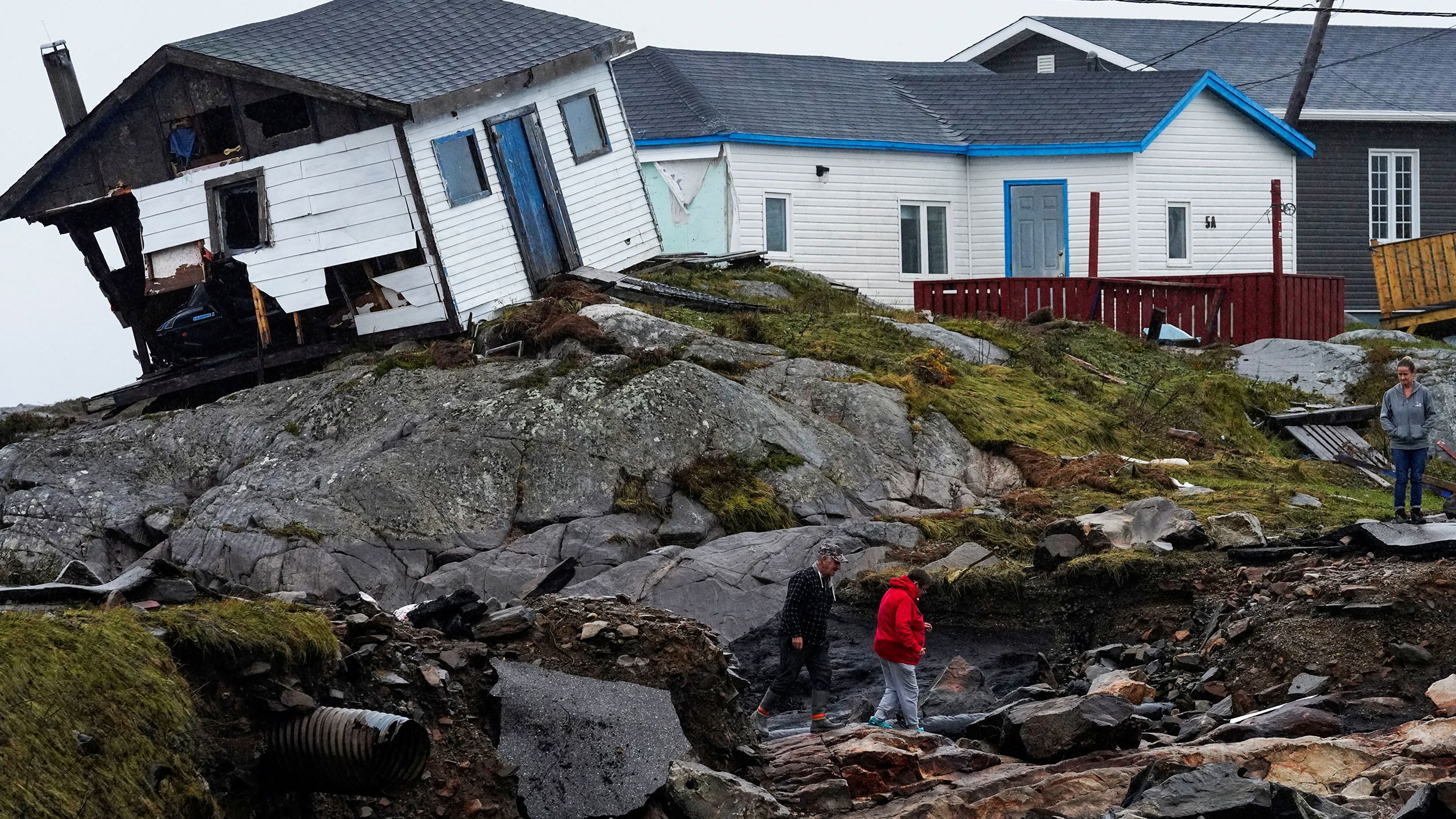 People head to their homes in Canada's Burnt Islands on Tuesday, September 27. The storm named Fiona <a href="http://www.cnn.com/2022/09/24/weather/gallery/hurricane-fiona-canada/index.html" target="_blank">slammed into Canada's eastern seaboard</a> with hurricane-force winds and torrential rainfall.