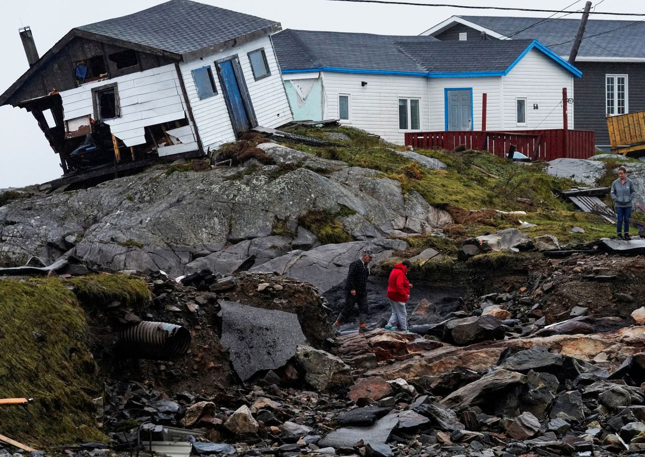 People head to their homes in Canada's Burnt Islands on Tuesday, September 27. The storm named Fiona <a href="http://www.cnn.com/2022/09/24/weather/gallery/hurricane-fiona-canada/index.html" target="_blank">slammed into Canada's eastern seaboard</a> with hurricane-force winds and torrential rainfall.
