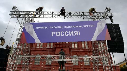Workers fix a banner outside the Red Square in Moscow on Wednesday, ahead of a Kremlin-backed annexation plan of Ukrainian territory widely condemned by European leaders as illegal.
