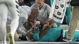 Miami Dolphins quarterback Tua Tagovailoa is examined during the first half of the team's NFL football game against the Cincinnati Bengals, Thursday, Sept. 29, 2022, in Cincinnati. (AP Photo/Jeff Dean)