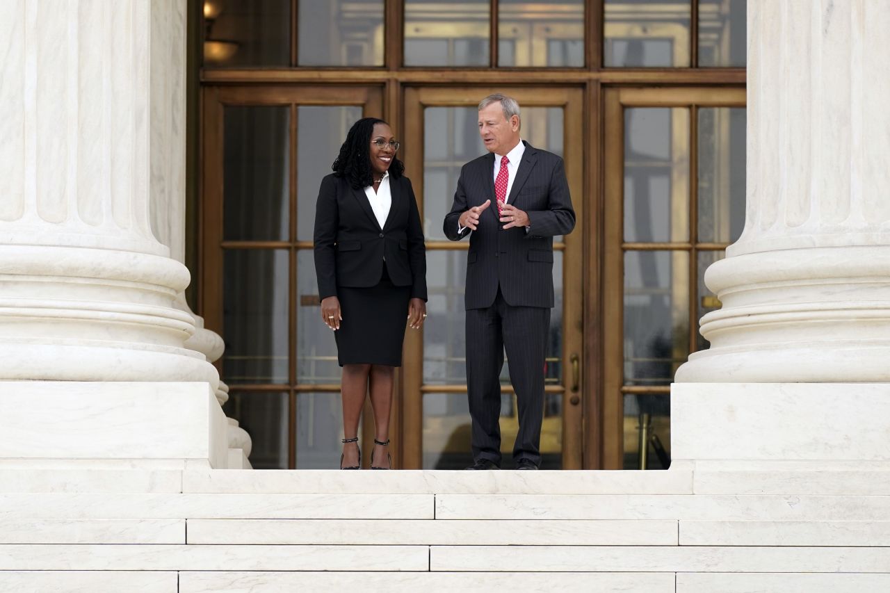 Jackson and Roberts walk outside the Supreme Court, where they posed for photos after her investiture ceremony.