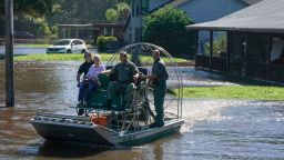 Osceloa County Sheriffs use a fanboat to rescue a 93 year-old resident from flooding following Hurricane Ian on September 30, 2022 in Kissimmee, Florida. - Forecasters expect Hurricane Ian to cause life-threatening storm surges in the Carolinas on Friday after unleashing devastation in Florida, where it left a yet unknown number of dead in its wake. After weakening across Florida, Ian regained its Category 1 status in the Atlantic Ocean and was headed toward the Carolinas, the US National Hurricane Center said Friday. (Photo by Bryan R. Smith / AFP) (Photo by BRYAN R. SMITH/AFP via Getty Images)