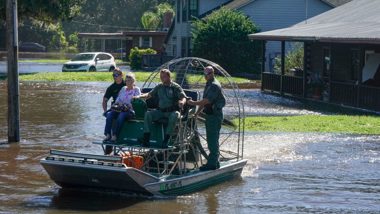 Osceloa County Sheriffs use a fanboat to rescue a 93-year-old resident from flooding on September 30 in Kissimmee, Florida.
