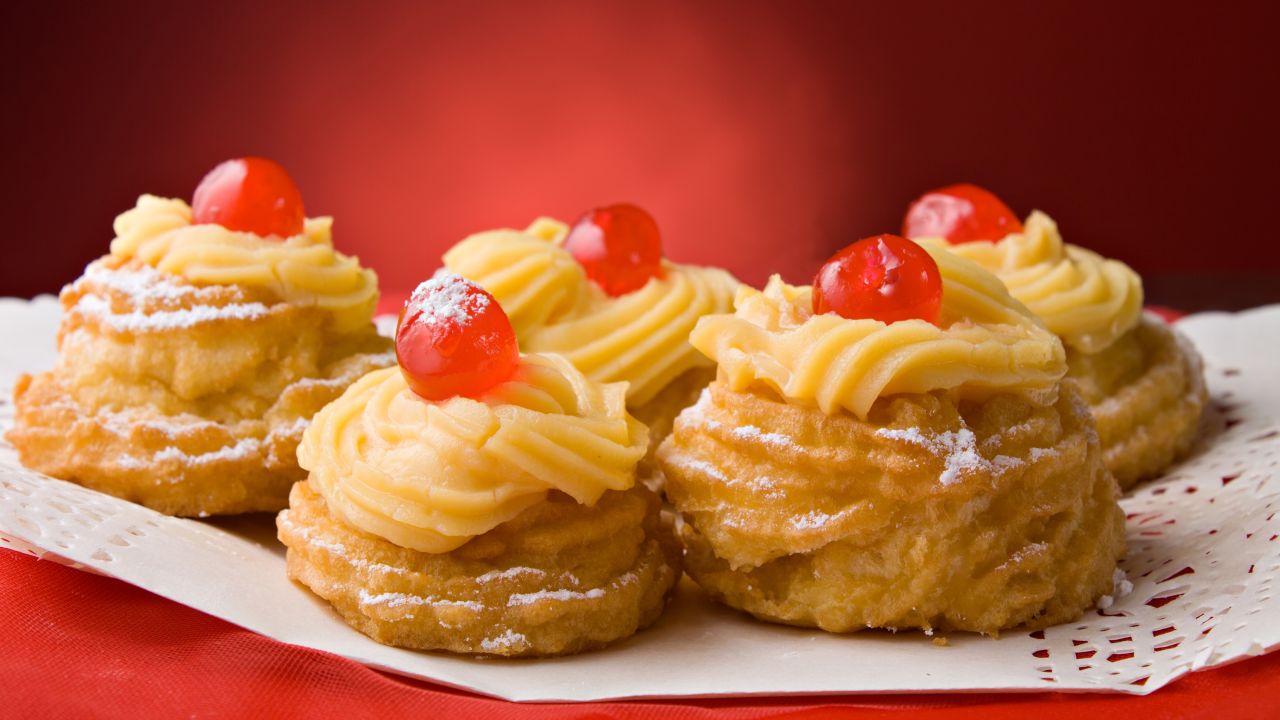 Zeppole are deep-fried doughnuts that can be served as sweet desserts, as shown here, or savory appetizers.