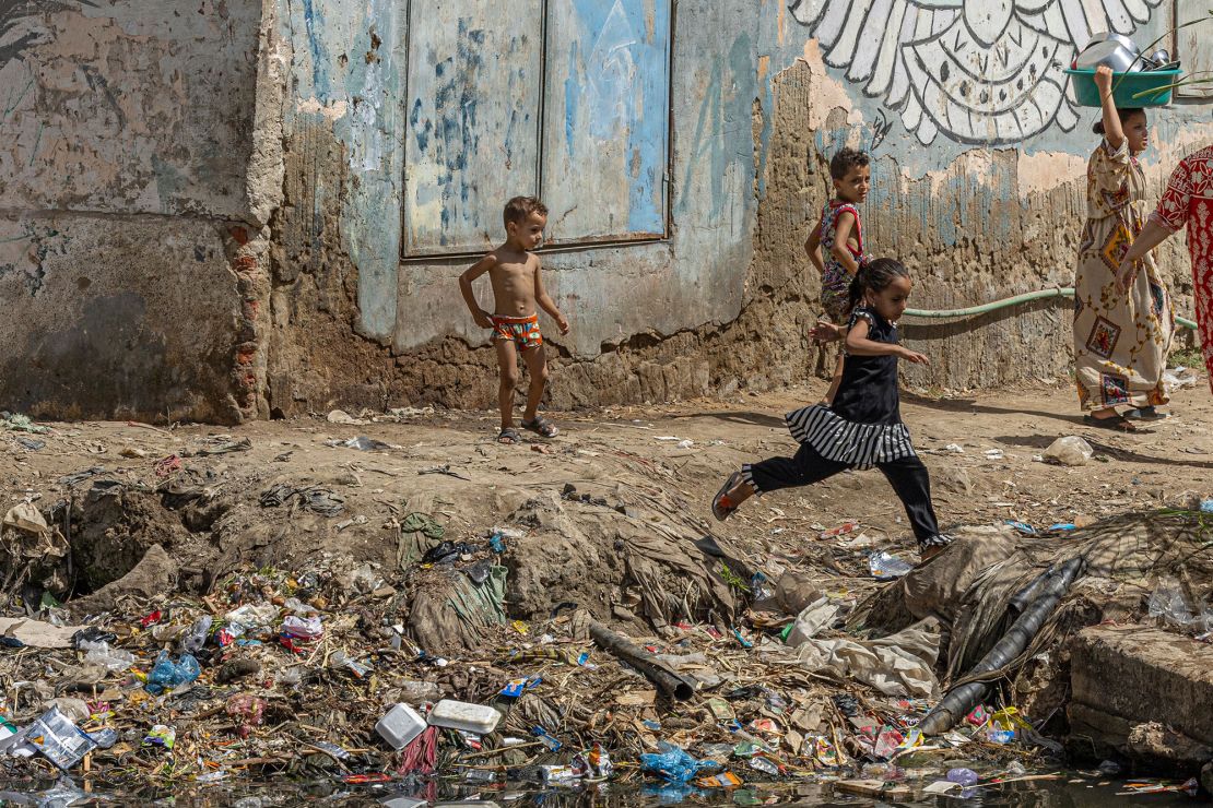 Egyptian children play on Thursday on the polluted banks of the Nile river in the Egyptian capital Cairo. Egypt will host the COP27 United Nations Climate Change Conference in November in its Red Sea resort of Sharm El Sheikh.  