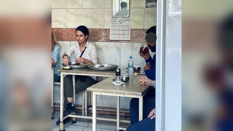 Donya Rad is seen in this image posted to social media in a Tehran restaurant. The face of the man on the right was obstructed in the original post to social media.